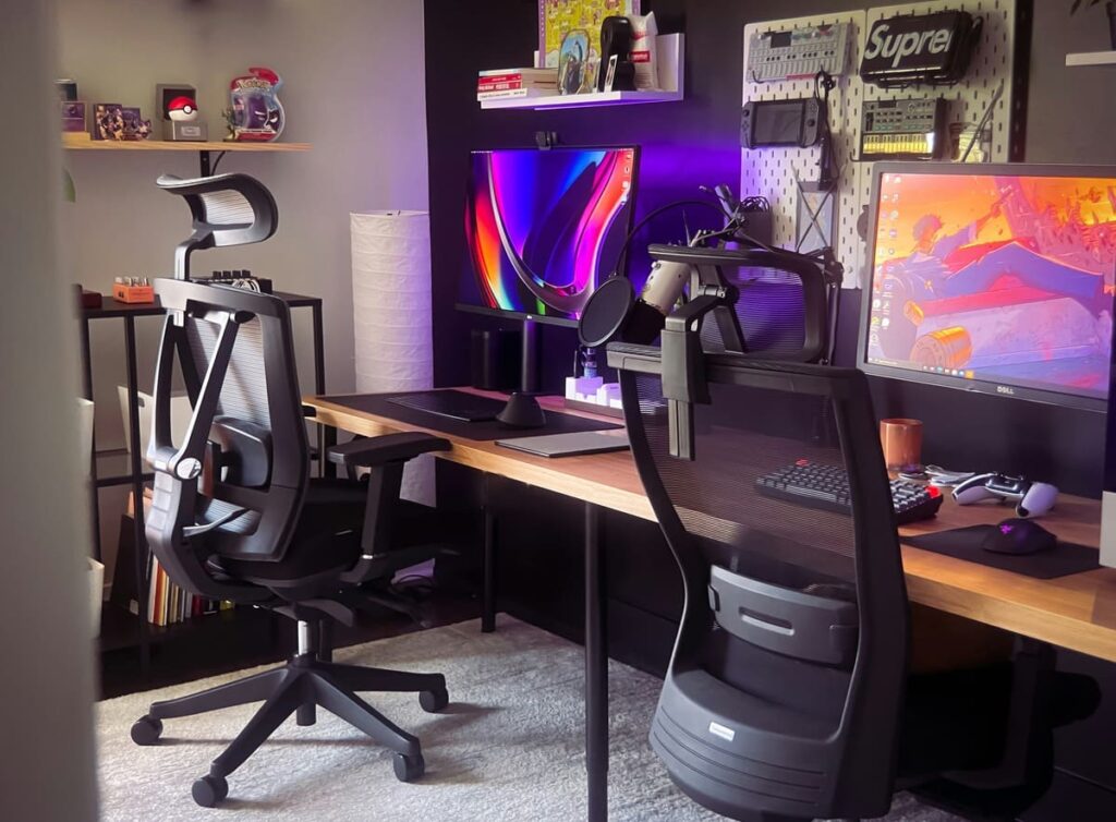 pair of ergonomic office chairs in a home office set up