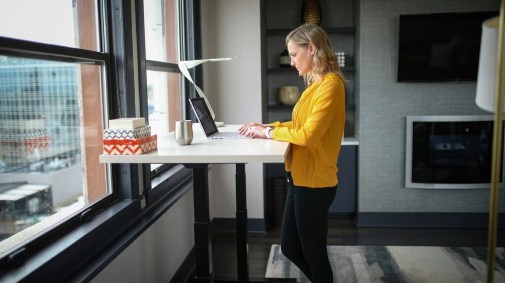 woman working from home in her office with a standing desk
