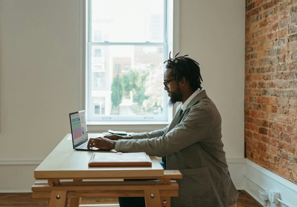 man sitting on desk working from home